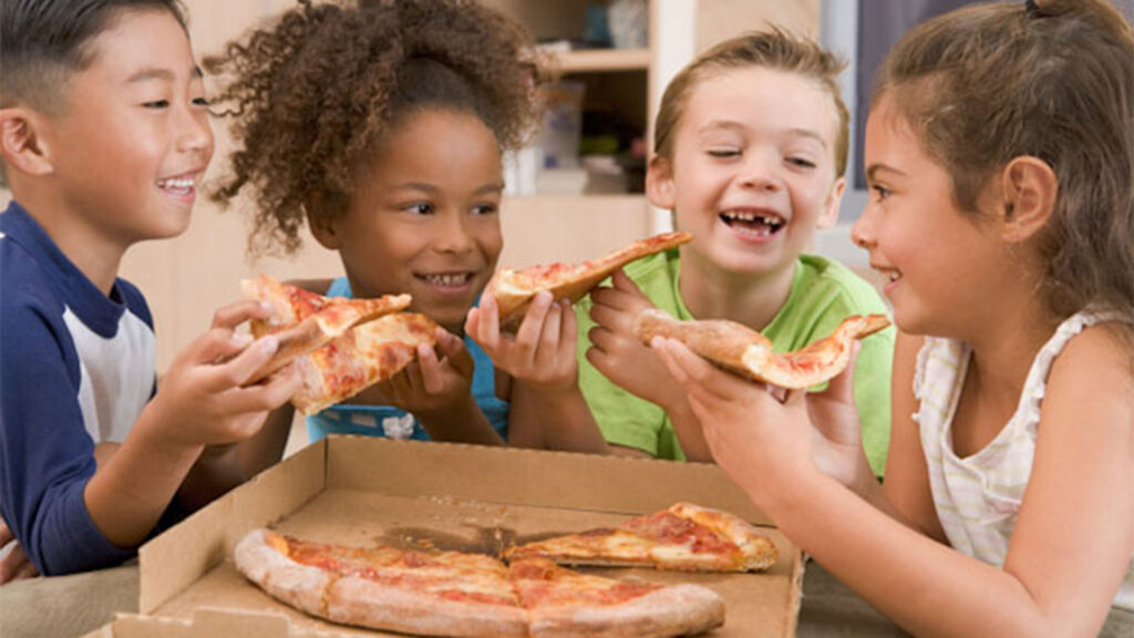 Kids love pizza at arcade birthday party